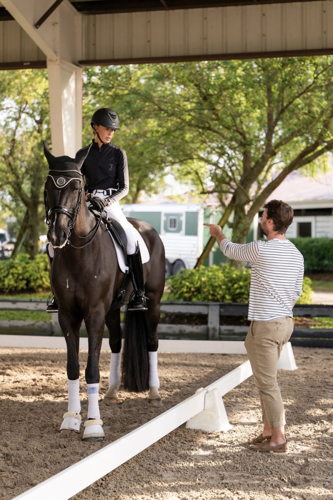 Coaching a rider in the arena